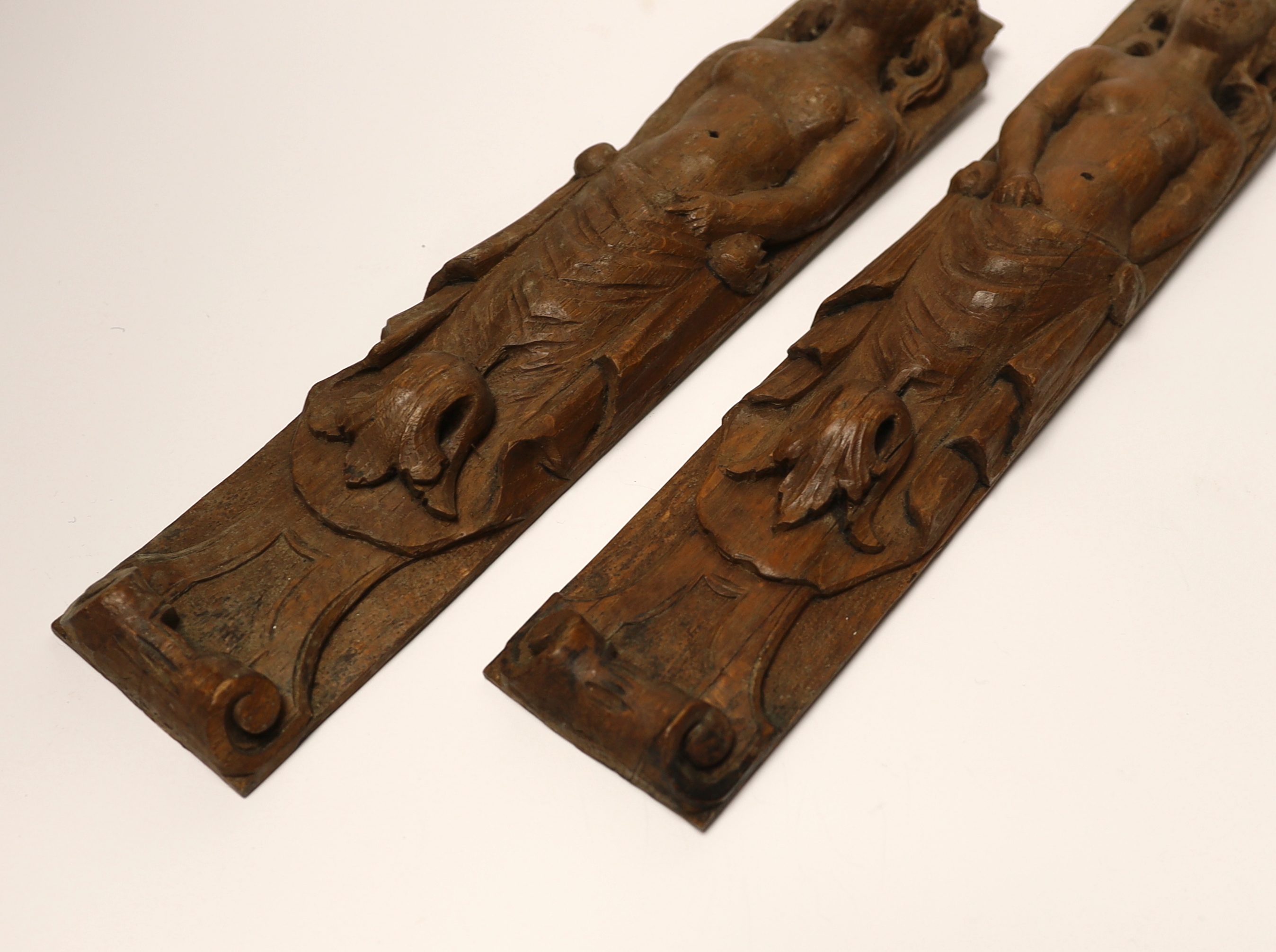 A pair of 17th century carved wood terminal figures, 39cm high